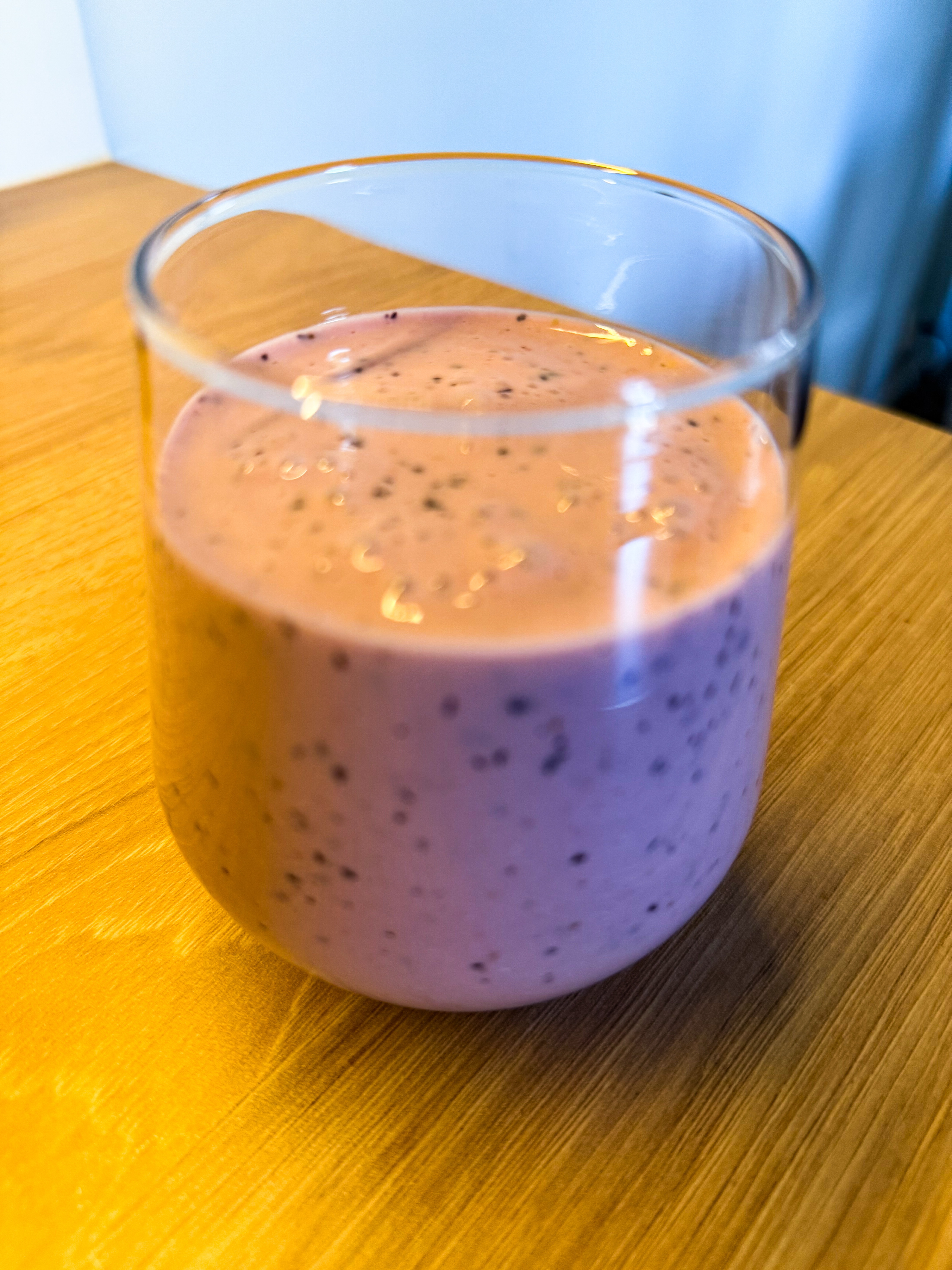 Breakfast smoothie on 2026-07-20: pink berry-banana smoothie in a glass with visible blueberry pieces