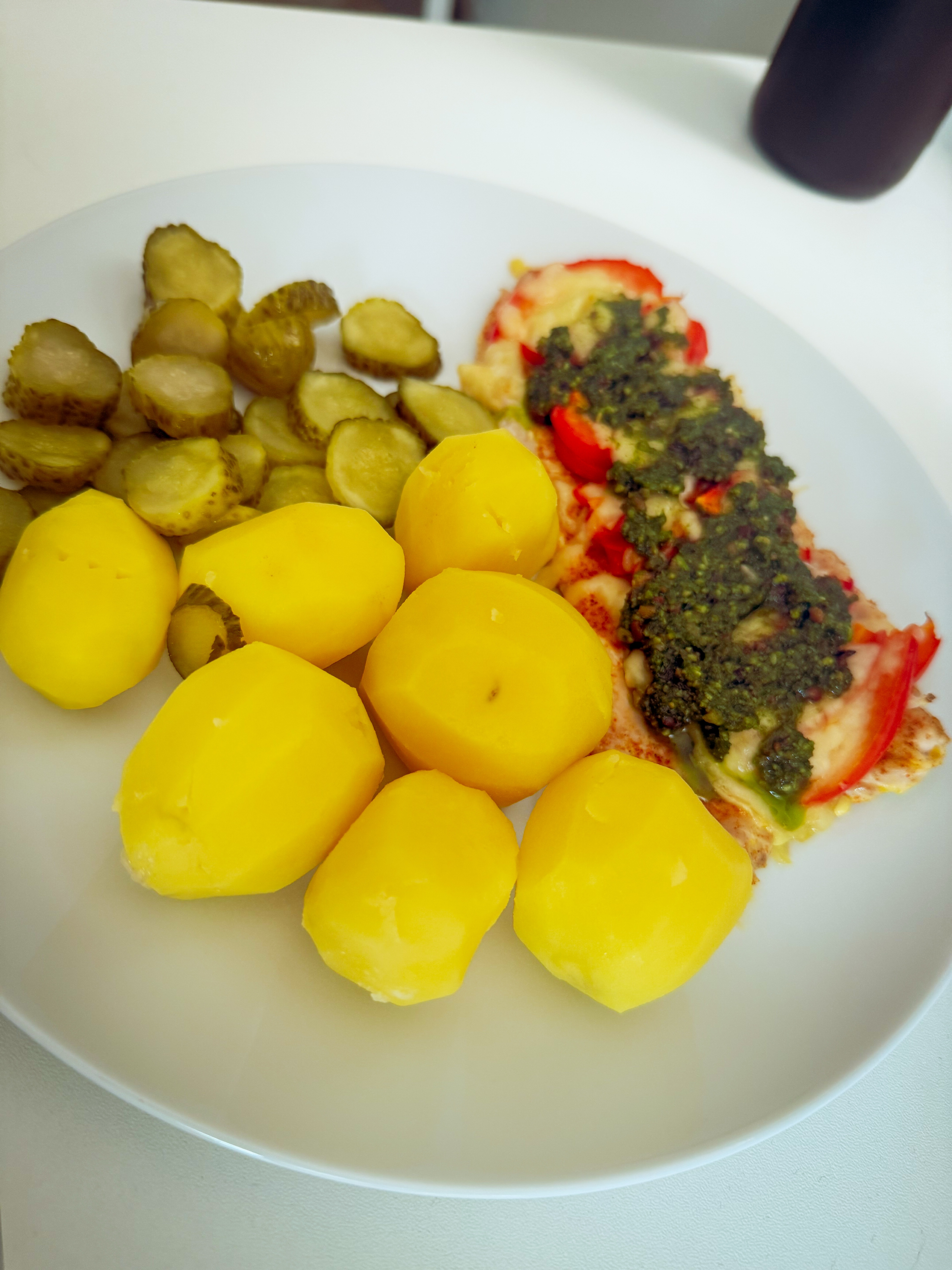 Dinner on 2026-07-25: boiled potatoes, sliced pickles, and a baked white-meat fillet topped with tomato, melted cheese, and green pesto
