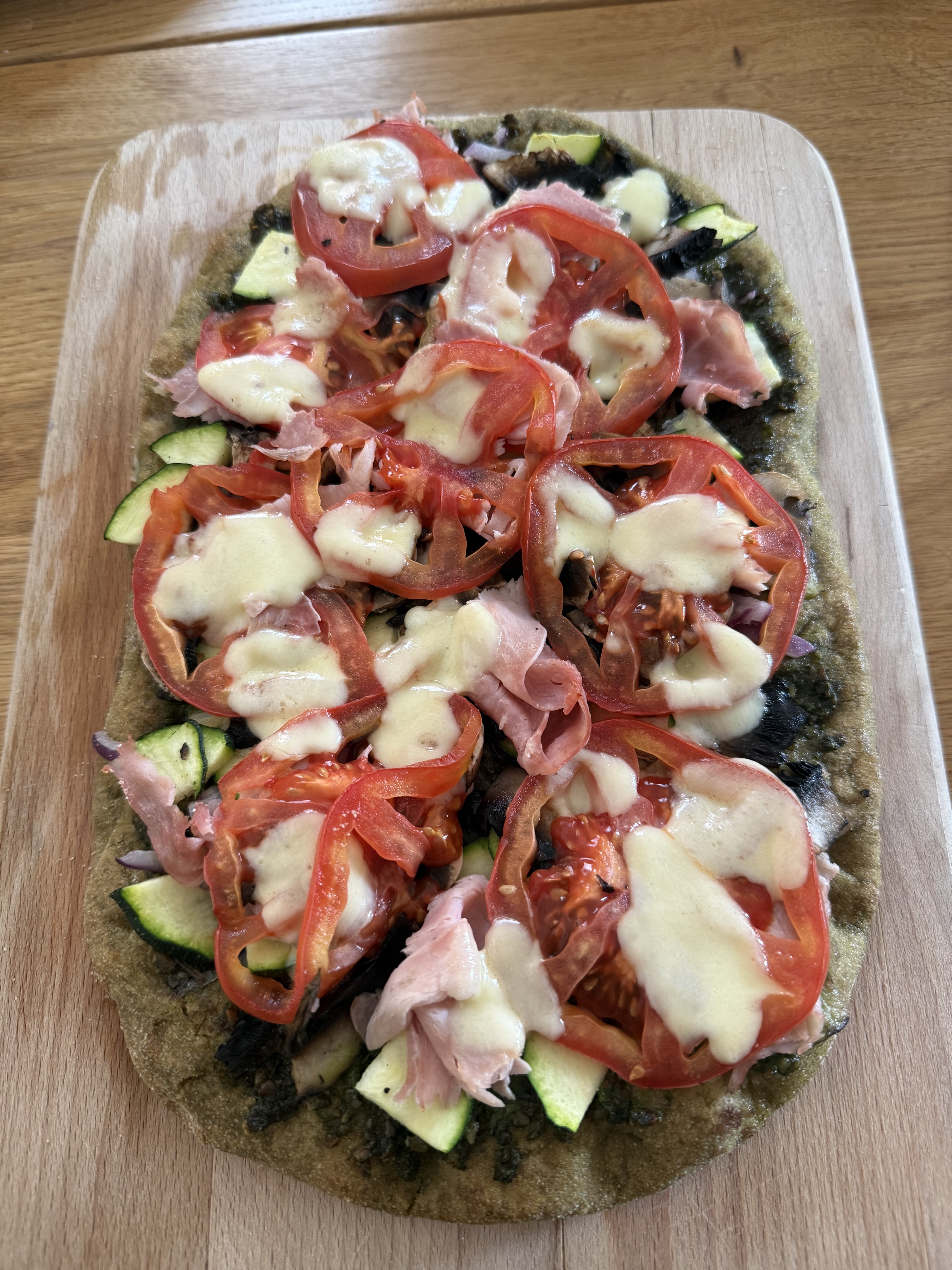 Dinner on 2026-07-26: pinsa with mozzarella, zucchini, onion, tomato, pesto, and champignons