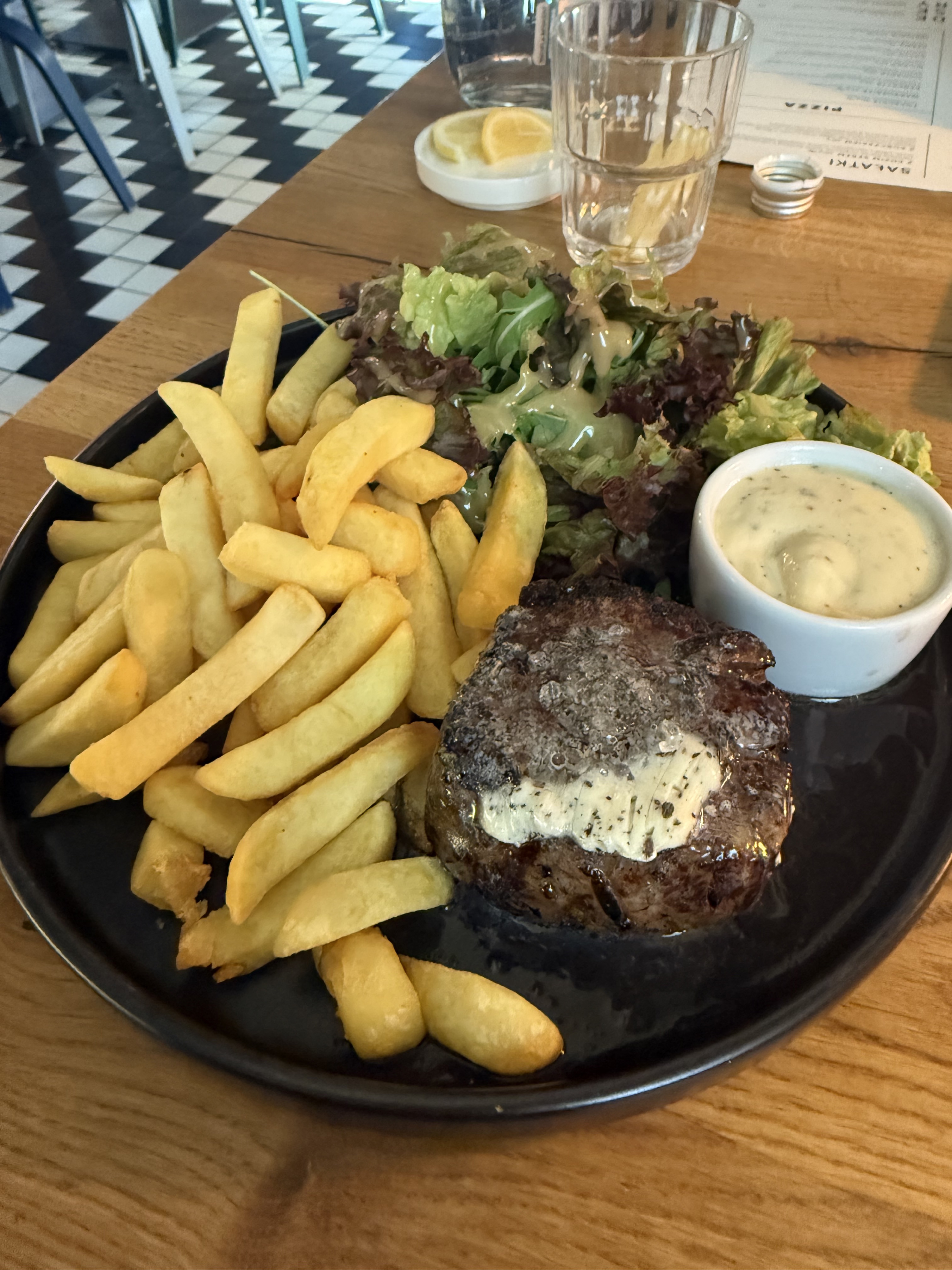 Dinner on 2026-07-31: beef steak or medallion with a pale topping, thick-cut fries, leaf salad with dressing, and a creamy dip